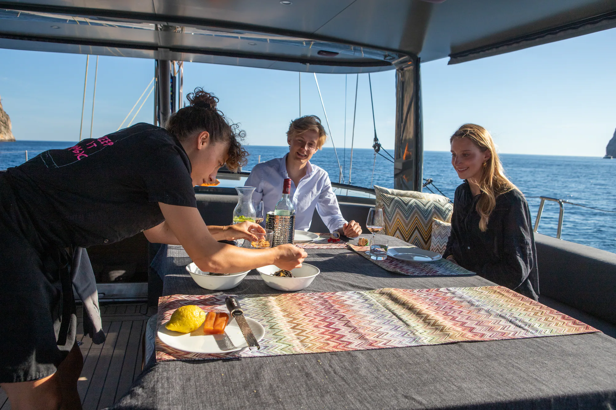 Two guests dining in the cockpit of Sailing Yacht W, the open sea beyond