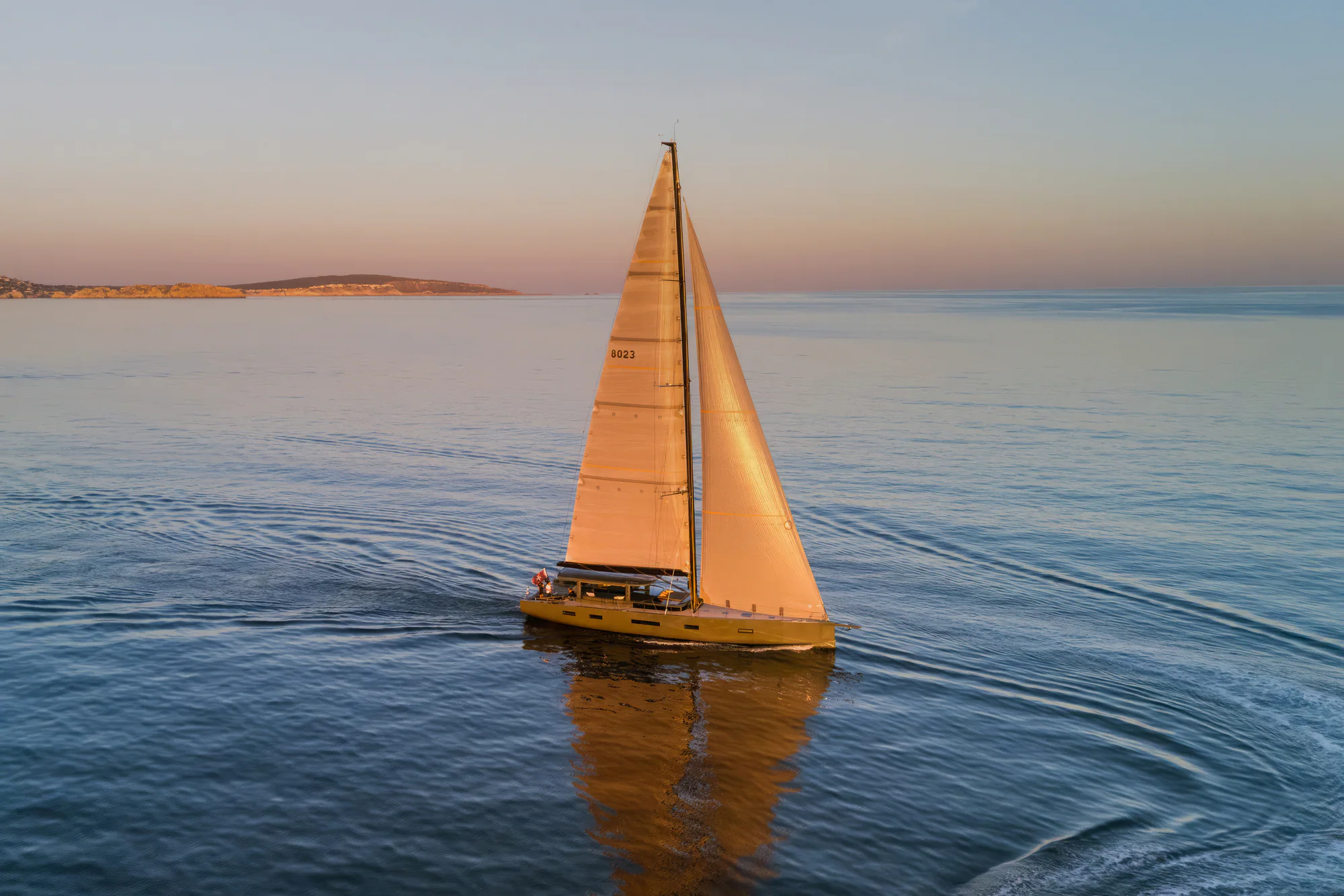 Sailing Yacht W under sail at golden hour in open water